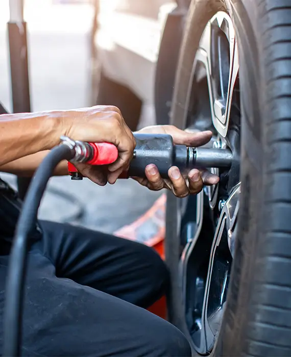 Florida Worker Changing Tire in Shop